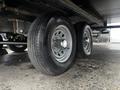 A close-up view of two wheels from a 2022 Aspen Trail trailer showcasing the tires and rims