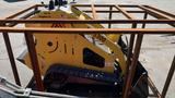 A yellow 2024 MachPro MP-S300 mini skid steer loader with tracks positioned inside a metal frame