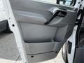 Interior door panel of a 2012 Mercedes-Benz Sprinter featuring a sleek design with a handle and a storage compartment