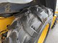 Close-up of a worn and damaged tire on a 2011 John Deere 310SJ 4x4 Wheel Loader Extended Hoe 4 in 1 showing deep treads and cracks