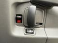 Close-up of the door handle and locking mechanism on a 2014 GMC Savana interior panel