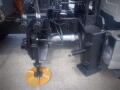 Close-up of a hydraulic system on a 2016 International WorkStar 7500 with control valve and yellow circular attachment for road maintenance tasks