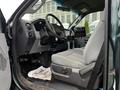 Interior view of a 2012 Ford F-550 showing the driver's seat dashboard and controls with a floor mat saying thank you