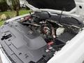 Close-up view of the engine compartment of a 2013 Chevrolet Silverado 3500HD showcasing various components including the engine block battery and fluids