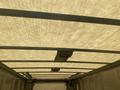 Interior view of a 2012 Ford Econoline cargo van showing the ceiling structure and overhead support beams