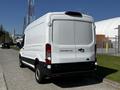 A white 2022 Ford Transit van viewed from the rear showing its taillights and the Transit 250 badge on the back door