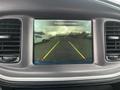 A digital display showing the rearview camera of a 2022 Dodge Charger with colored guidelines for parking assistance