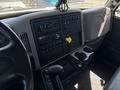 Interior view of a 2018 International DuraStar dashboard featuring a control panel with various buttons gauges and a radio display