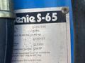A label on a 1997 Genie S-65 4X4 outlining specifications including model number weight voltage and date