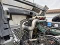 A close-up view of the engine of a 2012 Volvo VNL with various components including hoses and pipes visible under the hood