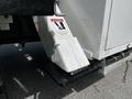 A 2012 Freightliner M2 106 truck with a metal step and warning label indicating to stand clear