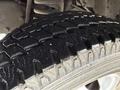 Close-up of a tire from a 2012 Ford Econoline showcasing the tread pattern and sidewall details