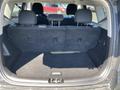 The interior of a 2017 Kia Soul showing the back cargo area with folded down seats and a black floor mat