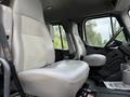Interior view of a 2005 Freightliner M2 106 showing two gray vinyl seats with a simple design and seatbelts
