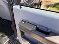 Interior door handle of a 2014 Ford F-250 SD in a gray color with a sleek design and textured grip