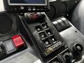 Close-up of the control panel of a 2012 Autocar Xpert featuring buttons labeled R N D and MODE along with switches and LED displays