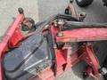 A red Toro Groundsmaster 5910 lawn mower with visible metal components and wheels positioned on a gray surface