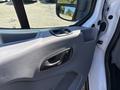 Interior view of a 2016 Ford Transit door handle and control panel with gray trim and a window switch