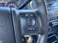 The image shows the steering wheel controls of a 2016 Ford F-550 with buttons for media, volume, seek, and an OK button