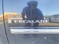 A 2007 Cadillac Escalade badge featuring the text 6.2 High Performance and Escalade with a reflective surface showing a person in a blue turban