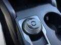 A close-up of the gear shift dial in a 2020 Ford Escape featuring a circular design with positions labeled P R N D and L