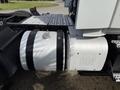 A 2012 Volvo VNL truck with a partially visible fuel tank and exhaust system showing the word HOT on the tank surface
