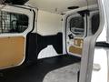 Interior view of a 2016 Ford Transit Connect van showcasing the cargo area with a flat floor and bare walls