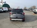 A 2019 Ford Escape parked with its rear facing the camera showcasing the tail lights and emblem