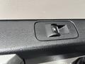 Close-up of a door lock switch in the interior of a 2016 Ford F-150 with a textured black surface and a sleek design