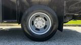 A close-up of a silver wheel and tire from a 2019 RAM 3500 showcasing the rim and tread design