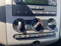 Dashboard controls of a 2013 Ford Expedition featuring climate control knobs and audio system buttons