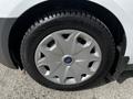 A close-up view of a silver wheel rim with a Ford logo and a Sailun tire, showcasing the tire tread and wheel design on a 2016 Ford Transit Connect