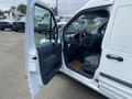 2013 Ford Transit Connect with an open door showing the driver's seat and dashboard in the foreground