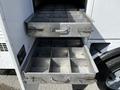 Two metal drawers filled with separate compartments, part of a utility body on a 2008 Ford F-550