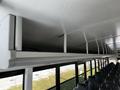 The interior of a 2022 Blue Bird Vision bus showing overhead storage compartments and rows of empty seats