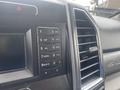 The interior control panel of a 2017 Ford F-550 featuring a keypad with numbers and letters and an air vent on the right