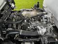 Engine compartment of a 2022 Isuzu NPR showing various pipes and components of the engine system