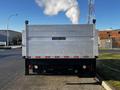 A 2014 Mitsubishi Fuso FE truck with a metallic silver bed and a Tommy Gate liftgate on the rear