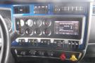 Dashboard of a 2015 Kenworth T660 featuring gauges buttons and a radio display