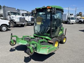 A 2016 John Deere 1585 Terrain Cut lawn mower with a protective cab and dual front mowers, featuring a green and yellow color scheme and large front wheels