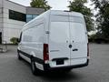 A 2019 Mercedes-Benz Sprinter van in white with a sleek design and a prominent rear door featuring the brand logo and model name on the back