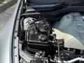 Close-up view of the engine compartment of a 2004 BMW 6-Series featuring various engine components and tubing