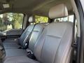 The interior of a 2020 Ford F-550 with two front seats and a rear bench seat featuring gray upholstery and headrests
