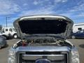 A 2014 Ford F-350 SD with its hood lifted revealing the engine compartment