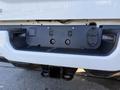 A 2023 RAM 3500 pickup truck with a visible hitch receiver and wiring plug in the rear bumper area