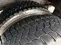 Close-up of two heavy-duty tires showing a deep tread pattern designed for traction and durability