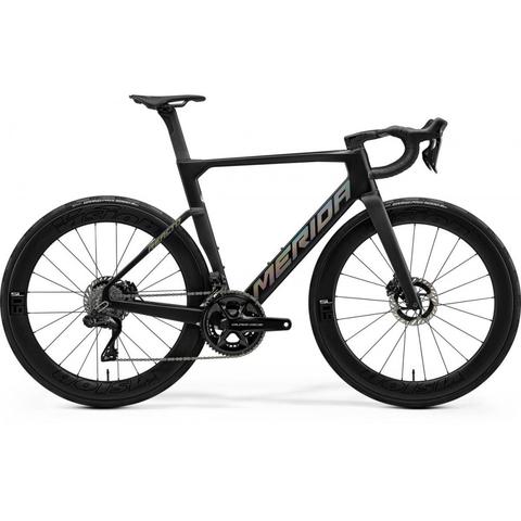 A 2026 Merida Reacto Team Road Bike featuring a sleek black frame with bold branding and aerodynamic design with disc brakes and high-performance wheels
