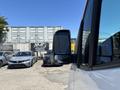 A 2019 Mercedes-Benz Sprinter van with a reflective side mirror prominently displayed in the foreground