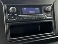 Dashboard radio control panel of a 2020 Mercedes-Benz Sprinter with digital display and various buttons for tuning and media options