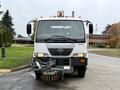 A 2009 UD Trucks UD 3300 street sweeper with a front-mounted broom equipped for cleaning roads and pavements